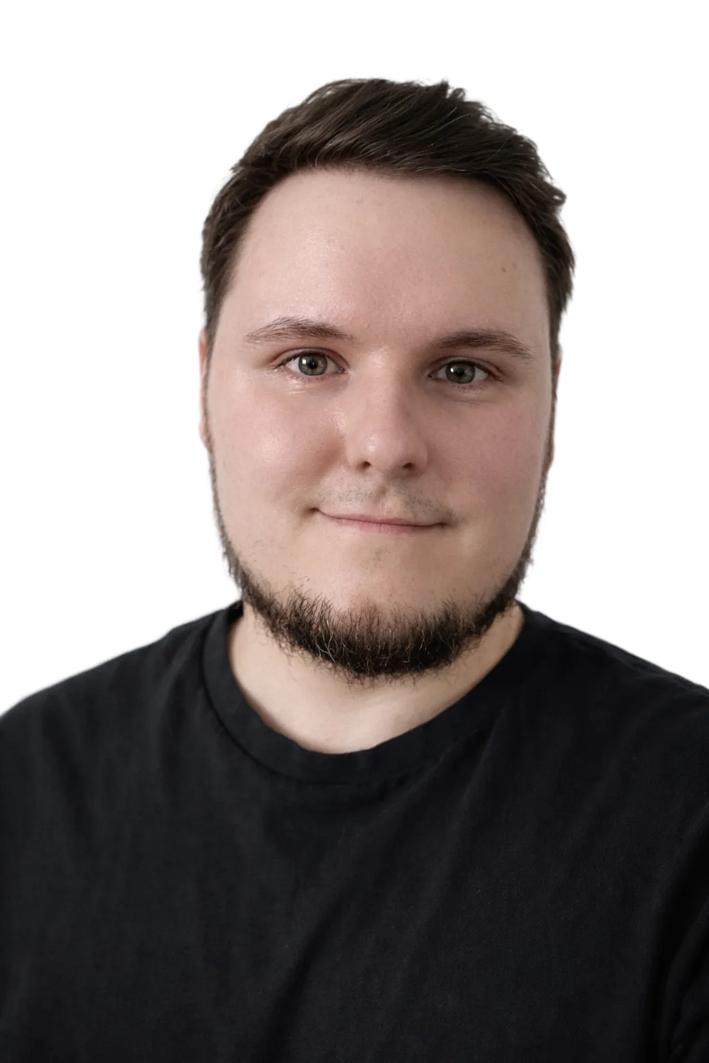 Portrait of a young smiling man with short hair, a short beard and a black t-shirt.